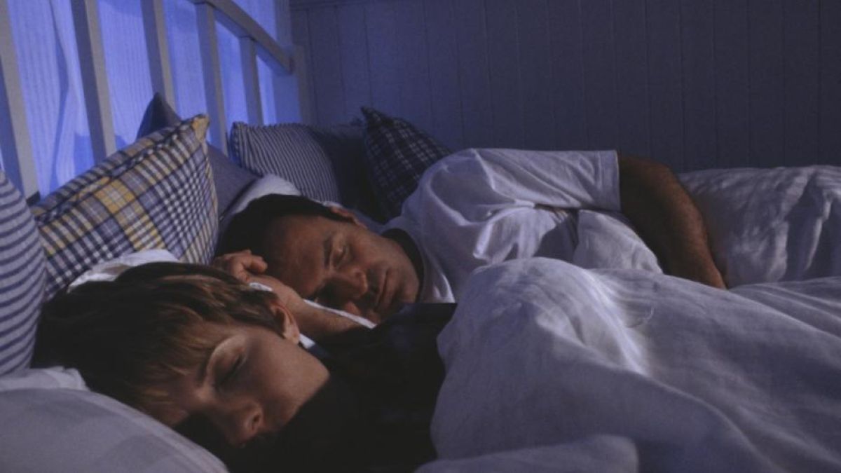 Man and woman sleeping with weighted blanket