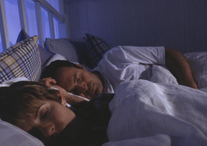 Man and woman sleeping with weighted blanket