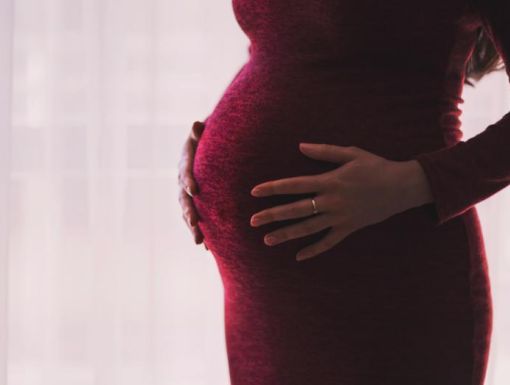 Pregnant woman holding her belly