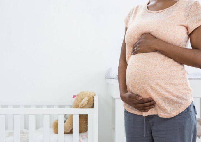 Pregnant mother holding bump 3