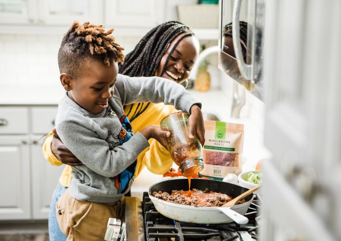 Mom getting kid involved in the kitchen