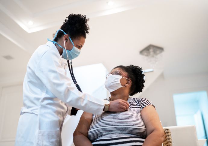 Doctor checking patients heart