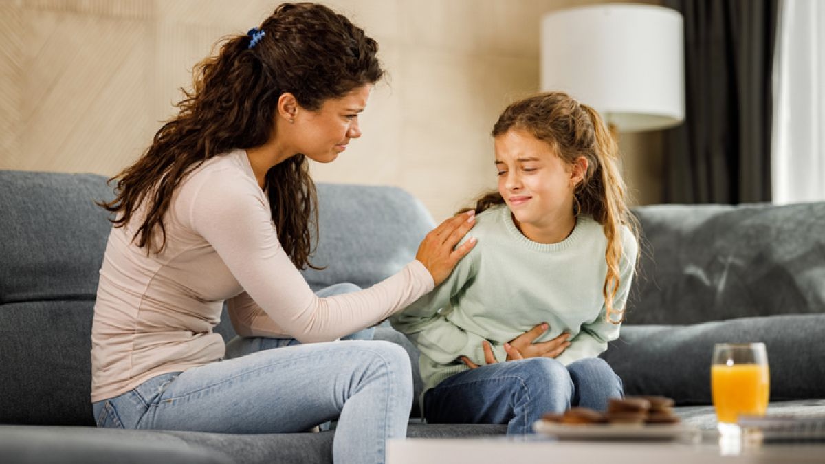 Mother taking care of child with upset stomach