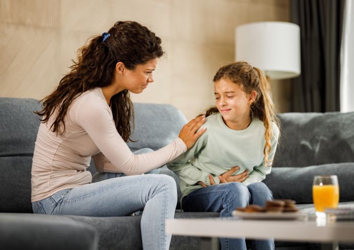 Mother taking care of child with upset stomach