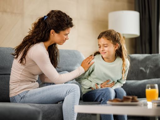 Mother taking care of child with upset stomach