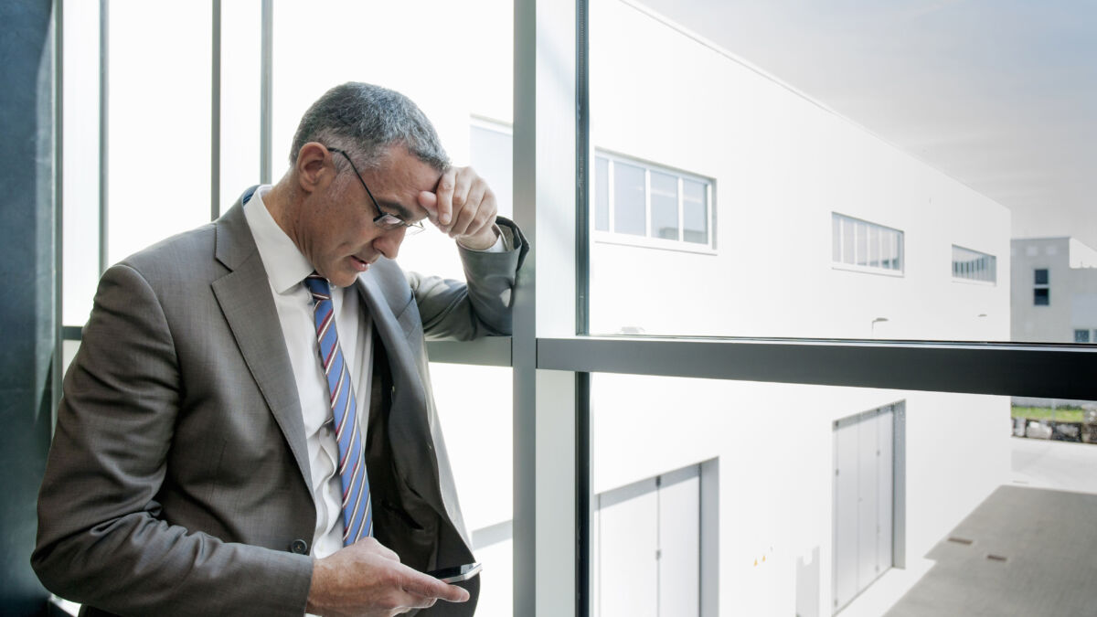 Man with high functioning anxiety looking at phone