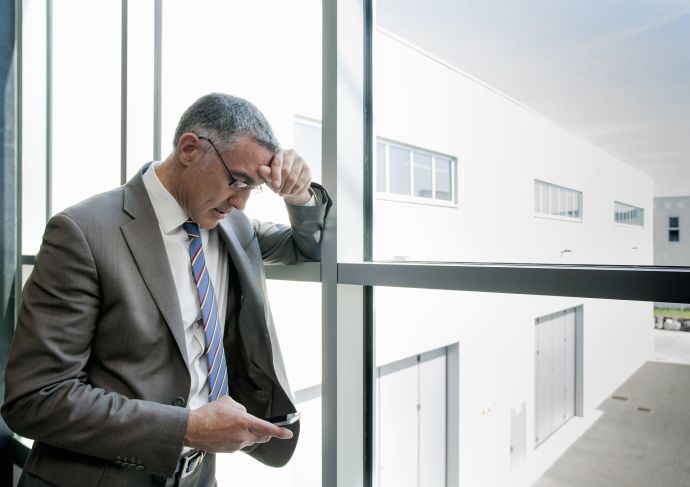 Man with high functioning anxiety looking at phone