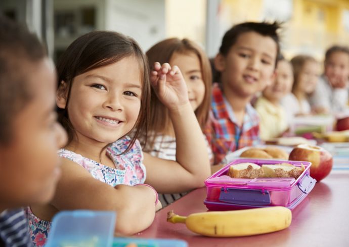 Kids at school lunch table with better school breakfast options