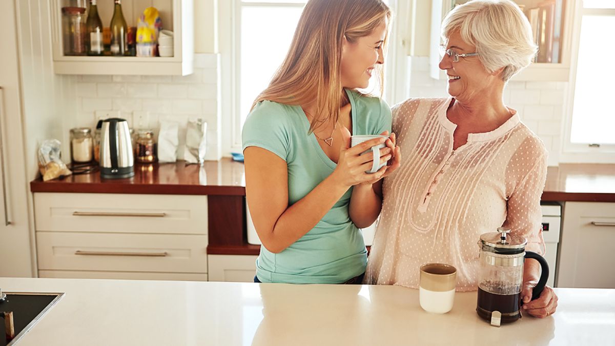 Mother and Daughter Drinking Coffee in the Kitchen