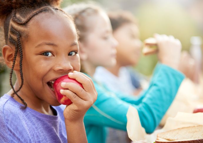 Young girl with IBD eating apple