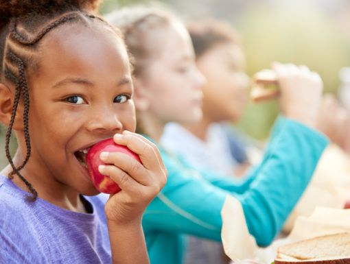 Young girl with IBD eating apple