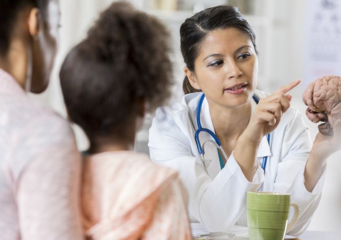 Doctor talking to mother and child