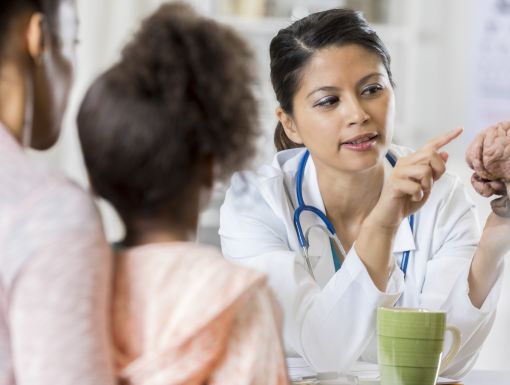 Doctor talking to mother and child