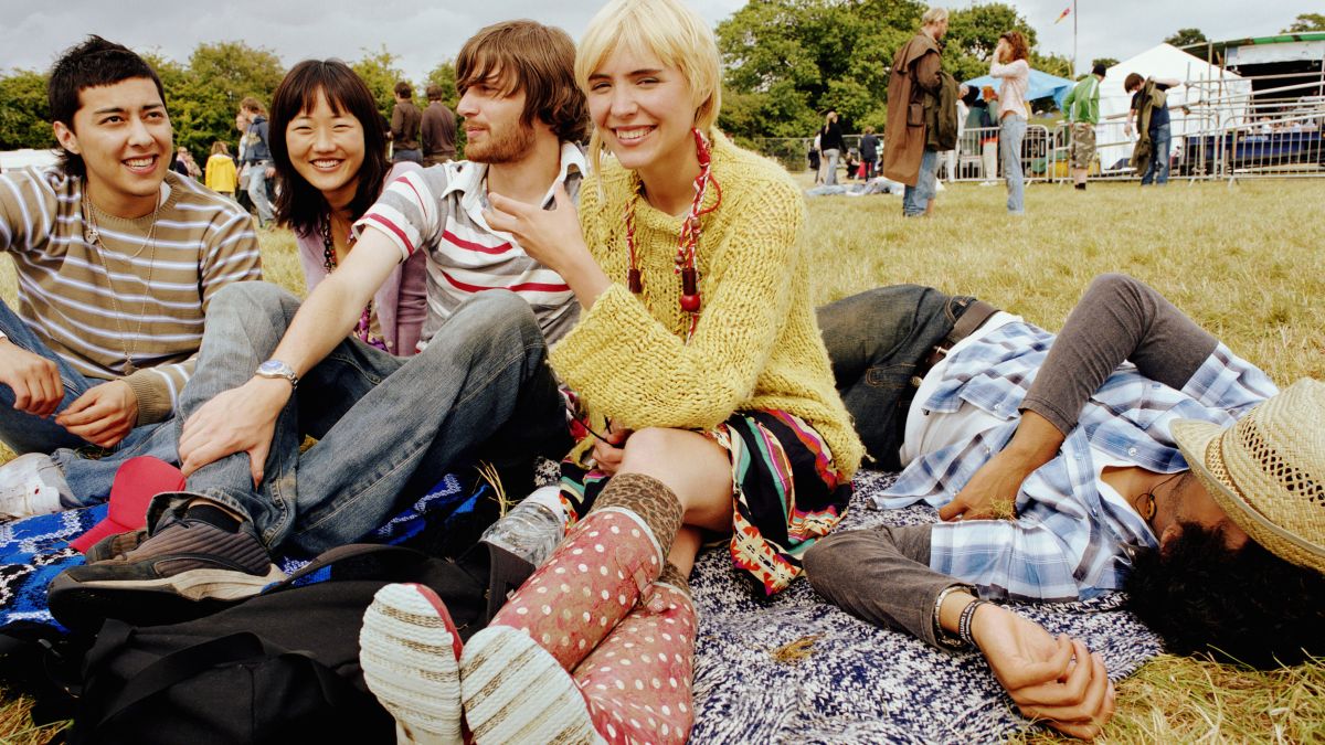friends sitting outside enjoying a festival