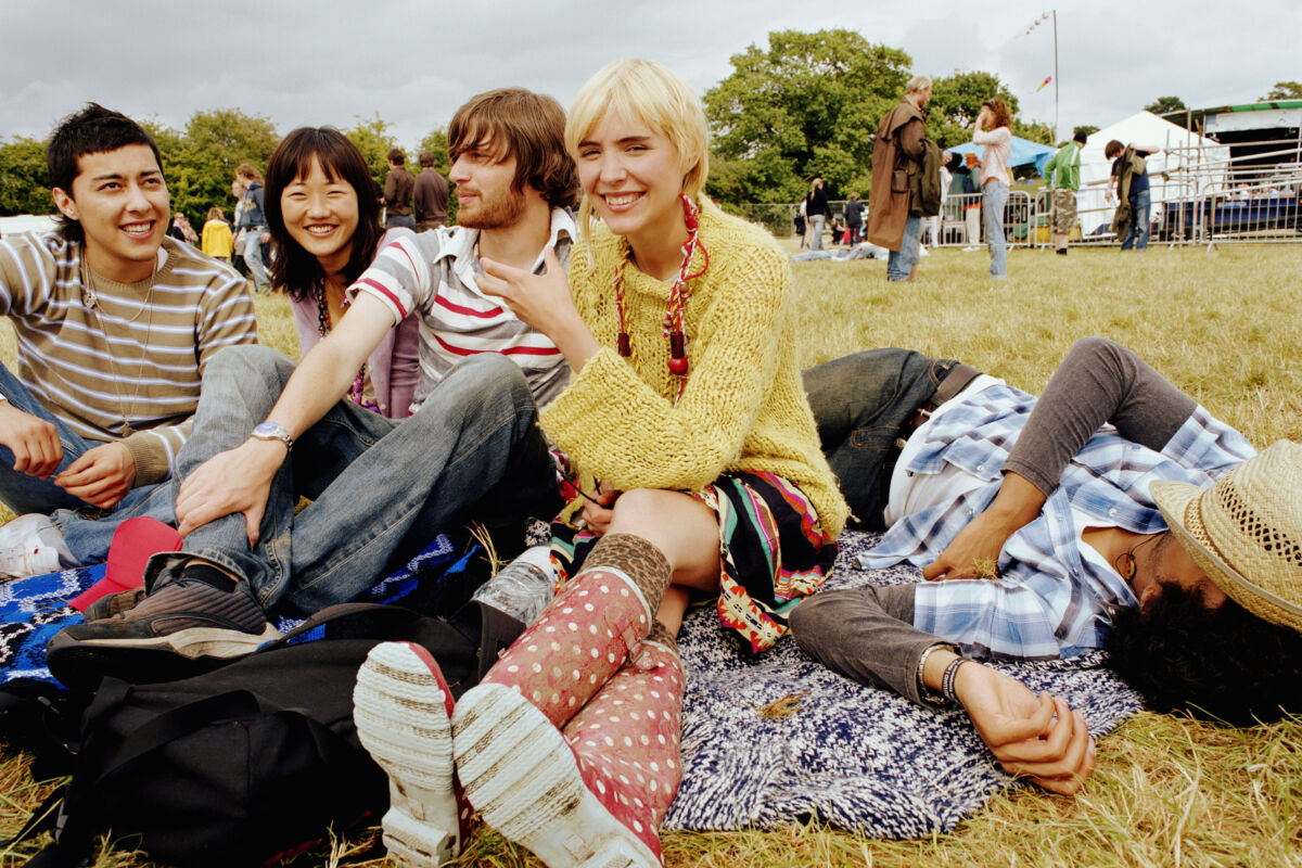 friends sitting outside enjoying a festival