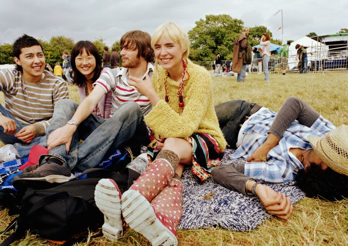 friends sitting outside enjoying a festival