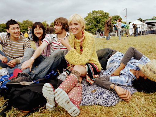 friends sitting outside enjoying a festival