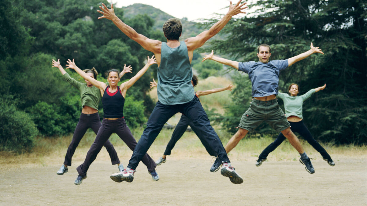 Group of people exercising and jumping outside