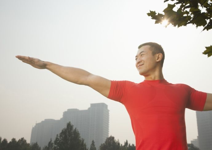 Thinkstockphotos 184565078 Muscular Man Stretching In Park