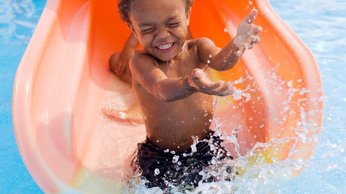 Little boy playing in swimming pool
