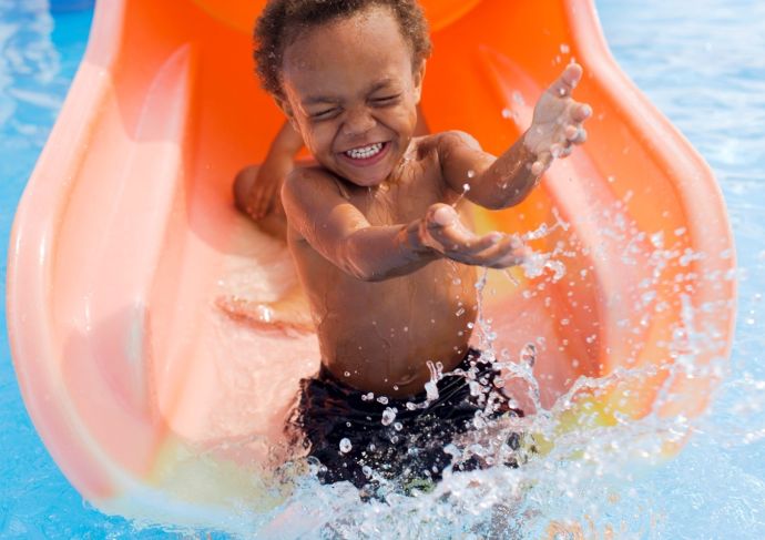 Little boy playing in swimming pool