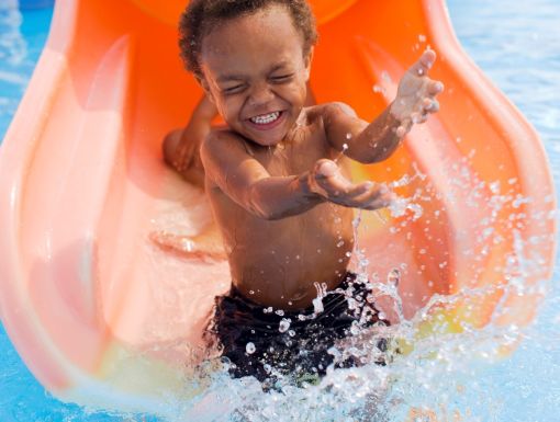 Little boy playing in swimming pool