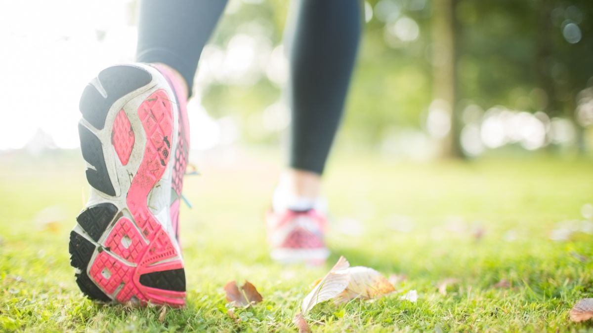 Woman stretching while wearing her running shoes