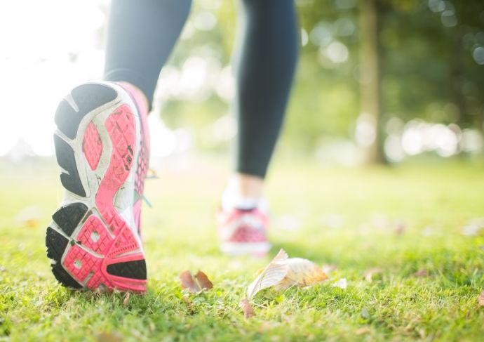 Woman stretching while wearing her running shoes