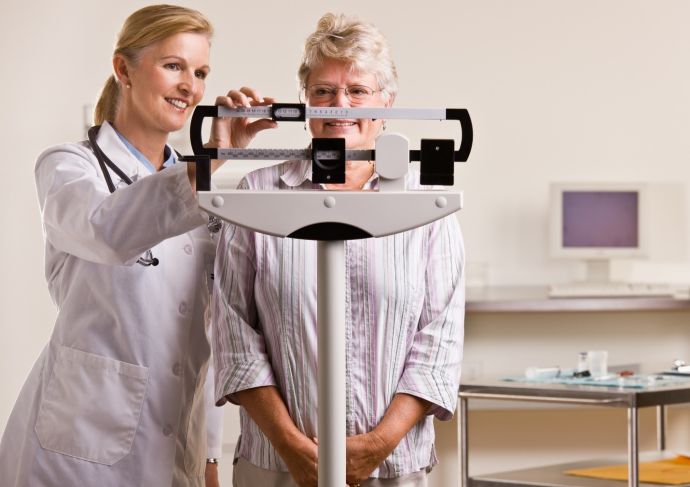 Physician Weighing Patient Scale