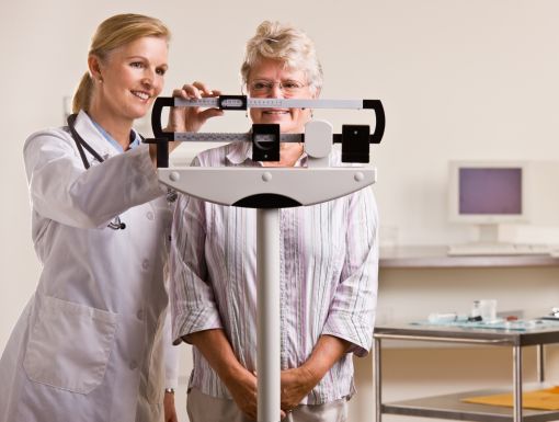 Physician Weighing Patient Scale