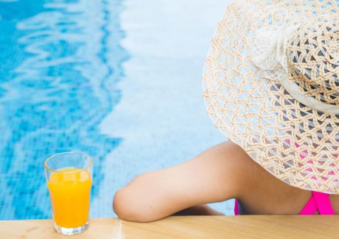 Thinkstockphotos 487320338 Woman Poolside With Hat And Juice Scaled