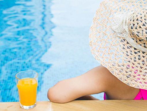 Thinkstockphotos 487320338 Woman Poolside With Hat And Juice Scaled