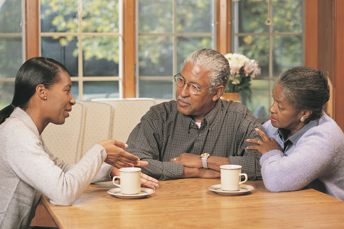 older couple talking to their daughter