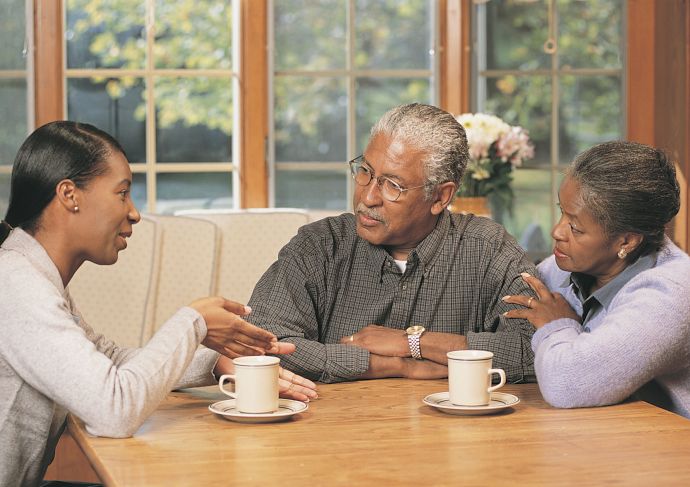 older couple talking to their daughter