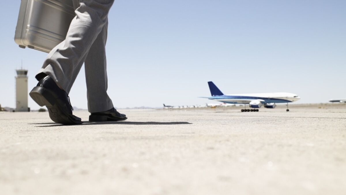 Thinkstockphotos 82186112 Businessman Walking Towards Airplane