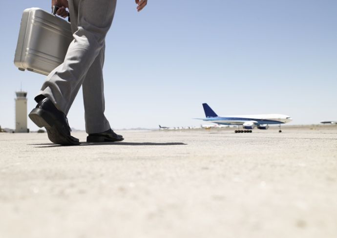 Thinkstockphotos 82186112 Businessman Walking Towards Airplane