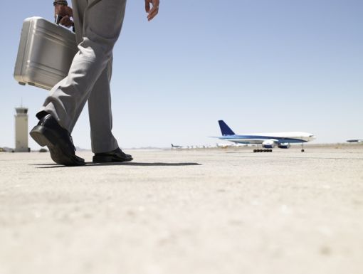 Thinkstockphotos 82186112 Businessman Walking Towards Airplane