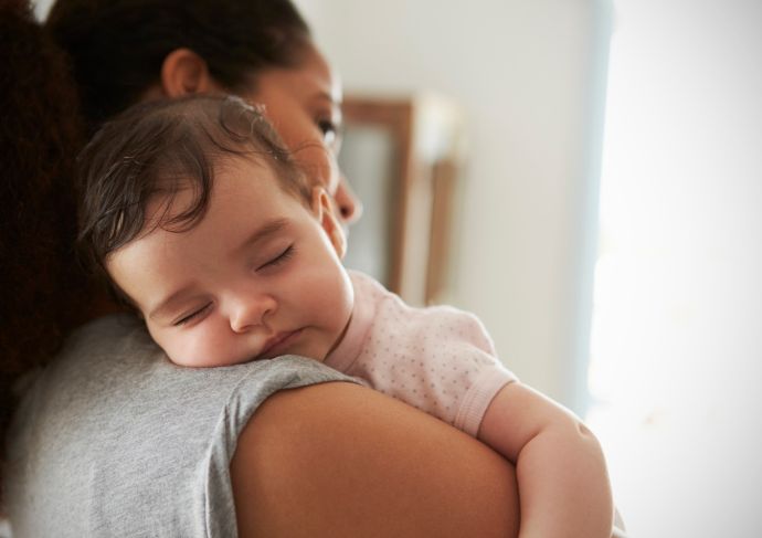 mother holding baby after feeding