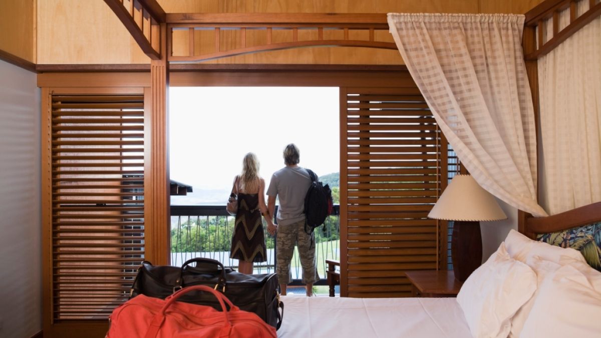 couple standing on balcony of hotel room