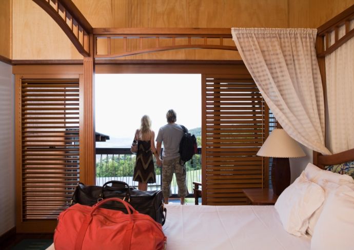 couple standing on balcony of hotel room