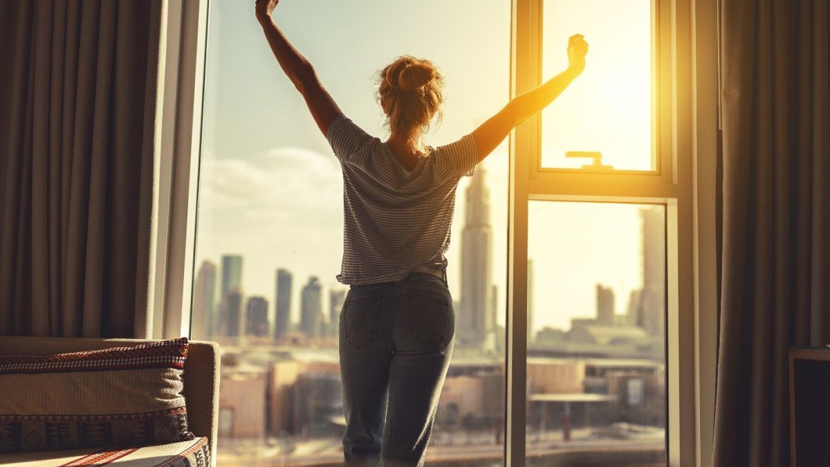 Thinkstockphotos 912257262 Woman Stretching Morning Window