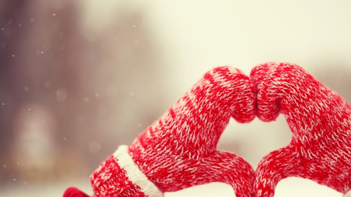 Pair of red mittens forming a heart.