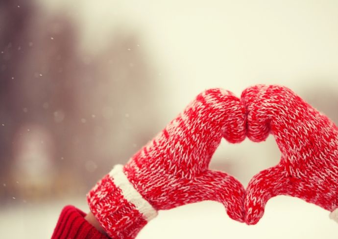 Pair of red mittens forming a heart.