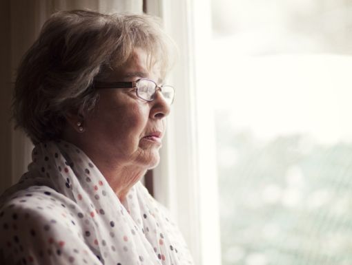 Thinkstockphotos 496352559 Senior Woman Looking Out Window