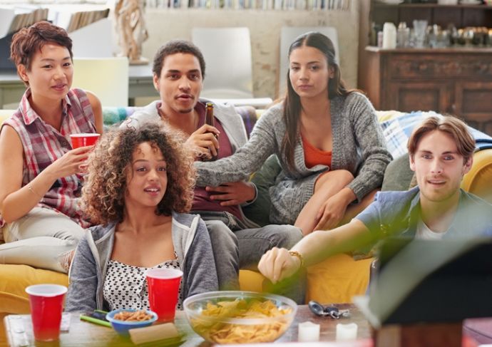 Friends watching football and enjoying healthy snacks