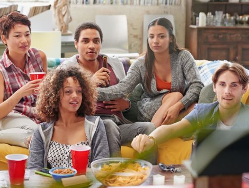 Friends watching football and enjoying healthy snacks