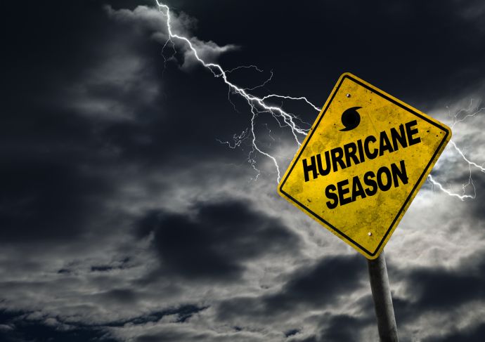 dark sky with a lightning bolt and a sign that says "hurricane season''