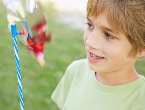 494377945 Boy Looking At Pinwheel