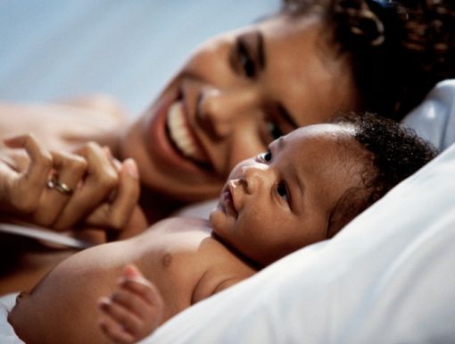 57567943 1 Mother Lying In Bed With Baby