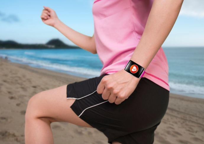 Woman Exercising On Beach Wearing Watchband Touchscreen